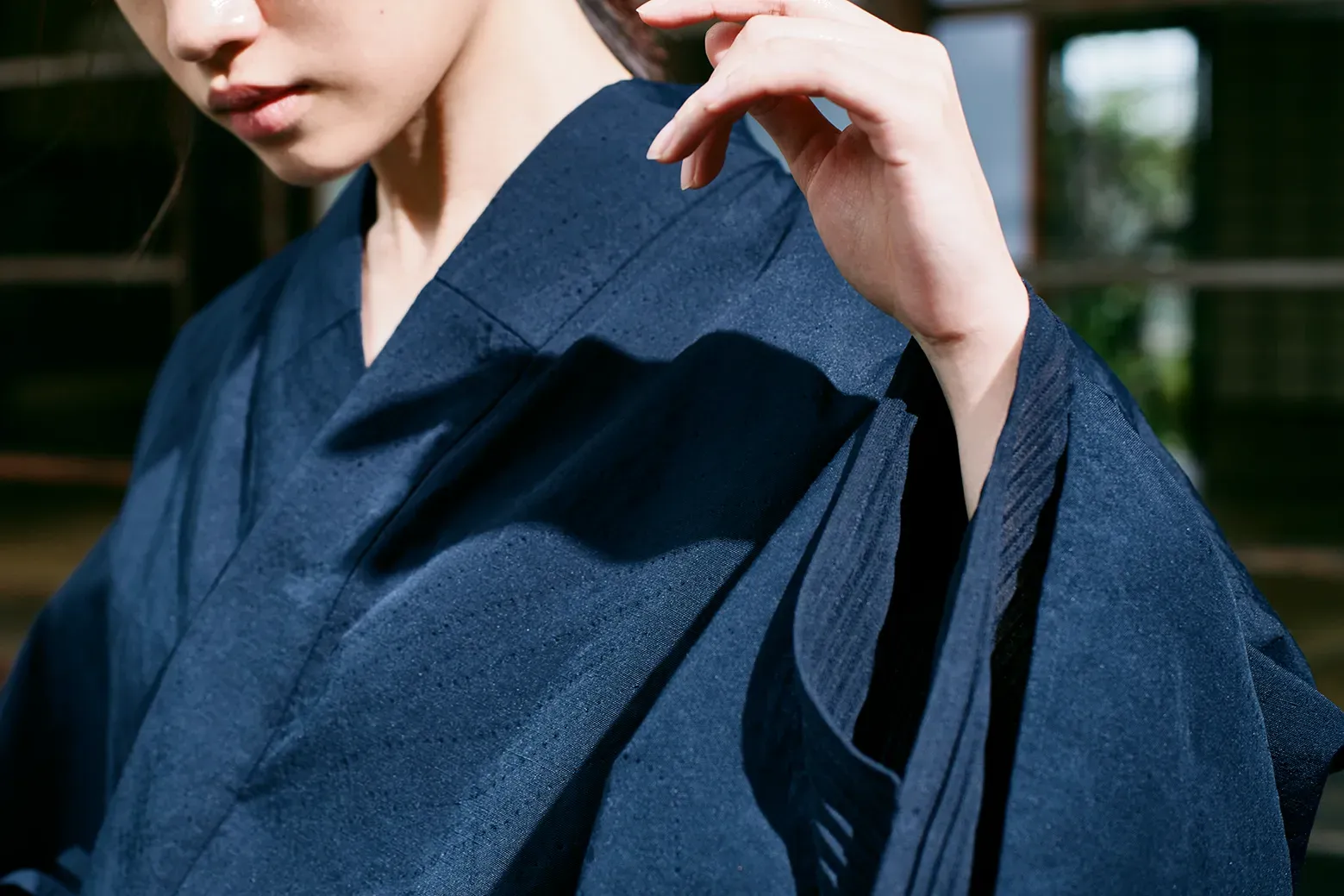 HOPE WEAR for Cultureの上半身拡大。濃紺生地の細かいパンチングと、重なる袖のプリーツ構造で通気性の革新を示している。